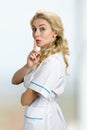 Attractive blond nurse gesturing silence. Royalty Free Stock Photo