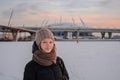 Attractive blond woman in hat with scarf and coat in winter at sunset Royalty Free Stock Photo