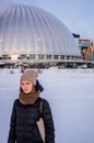 Attractive blond woman in hat with scarf and coat in winter at sunset Royalty Free Stock Photo