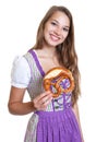 Attractive blond woman in a purple dress with pretzel Royalty Free Stock Photo