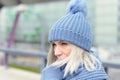 Attractive blond woman snuggling into a warm scarf Royalty Free Stock Photo