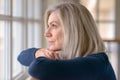 Attractive blond woman watching through a window Royalty Free Stock Photo