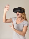 Attractive blond woman wearing headset VR virtual reality vision goggles watching video Royalty Free Stock Photo