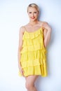 Attractive blond young woman posing in yellow dress Royalty Free Stock Photo