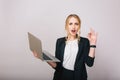 Attractive blonde businesswoman with laptop isolated on white background. Wearing office suit, stylish, fashionable Royalty Free Stock Photo