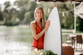 Attractive blonde girl holding a white wakeboard Royalty Free Stock Photo