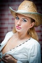 Attractive blonde girl with straw hat and white blouse Royalty Free Stock Photo