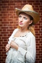 Attractive blonde girl with straw hat and white blouse Royalty Free Stock Photo