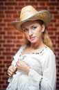 Attractive blonde girl with straw hat and white blouse Royalty Free Stock Photo