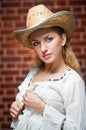 Attractive blonde girl with straw hat and white blouse Royalty Free Stock Photo