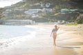 Attractive blonde girl walking on the beach, fit sporty healthy sexy body in bikini, woman enjoys sun, freedom, vacation Royalty Free Stock Photo