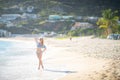 Attractive blonde girl walking on the beach, fit sporty healthy sexy body in bikini, woman enjoys sun, freedom, vacation Royalty Free Stock Photo