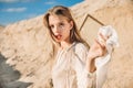 attractive blonde girl with white silk scarf walking