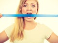 Attractive blonde woman biting tape on mouth. Royalty Free Stock Photo
