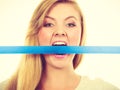 Attractive blonde woman biting tape on mouth. Royalty Free Stock Photo