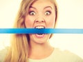 Attractive blonde woman biting tape on mouth. Royalty Free Stock Photo