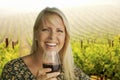 Attractive Blonde Woman Enjoying a Glass of Wine at the Vineyard Royalty Free Stock Photo