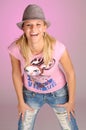 Attractive blonde woman with hat in pink T-shirt