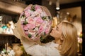 Attractive blonde woman is holding delicate pink bouquet of peony roses in her hands. Royalty Free Stock Photo