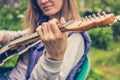 Attractive blonde woman playing a guitar outside in the countryside Royalty Free Stock Photo