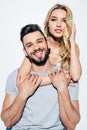 Attractive blonde woman hugging happy bearded man on white.