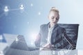 Attractive blonde young european businesswoman sitting on chair and using laptop computer with abstract glowing people and light Royalty Free Stock Photo