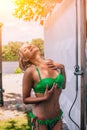 Attractive Blondie Young Woman In Green Bikini Is Taking Shower. Royalty Free Stock Photo