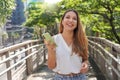 Brazilian female entrepreneur walking in Sao Paulo sustainable metropolis holding a smartphone