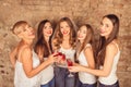 Attractive bride and happy bridesmaids celebrating hen-party with red champagne Royalty Free Stock Photo