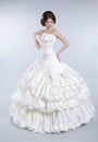 Attractive bride model girl wearing in wedding dress with voluminous skirt, studio photo Royalty Free Stock Photo