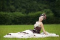 Attractive bride sitting on green field Royalty Free Stock Photo