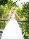 Attractive bride in white dress with bouquet, wedding day in the green park Royalty Free Stock Photo