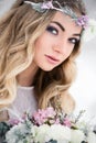 Attractive bride in the winter snow forest outdoors with beautiful flowers on her head and a bouquet. Wedding makeup Royalty Free Stock Photo