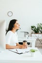 Attractive broker in headset sitting and