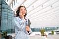 Attractive brunette businesswoman talking mobile phone with client. Pretty caucasian female business person smile when phone Royalty Free Stock Photo