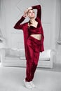 Attractive brunette dressed in a burgundy velor suit Royalty Free Stock Photo
