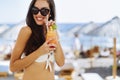 Attractive brunette drinking cocktails on beach Royalty Free Stock Photo