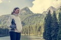 Attractive brunette enjoying lake view with surrounding forest. Royalty Free Stock Photo