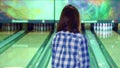 Girl knocks down pins at the bowling