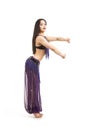 Attractive brunette girl with long hair dancing belly dance. Royalty Free Stock Photo