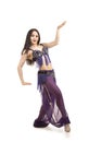 Attractive brunette girl with long hair dancing belly dance. Royalty Free Stock Photo