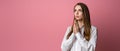 Attractive brunette girl prays for wellness of family keeps palms pressed together in praying gesture saying namaste