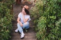 Attractive brunette in a hat and white shirt is enjoying nature in the mountains. Beautiful young woman in a shirt and Royalty Free Stock Photo