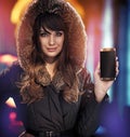 Attractive brunette holding a smartphone - autumn commercial