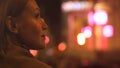 Attractive brunette lady looking at night city lights, megalopolis illumination