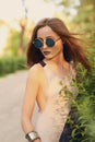 Attractive brunette modern woman with blue lips in round sunglasses Royalty Free Stock Photo