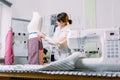 Attractive brunette woman fashion designer seamstress measuring mannequin in her fashion atelier Royalty Free Stock Photo