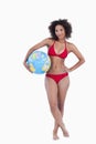 Attractive brunette woman holding a beach ball Royalty Free Stock Photo