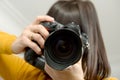 Attractive brunette woman with photo camera in studio