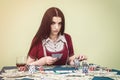 Attractive brunette woman with playing cards and poker table Royalty Free Stock Photo